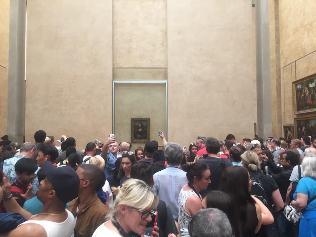 Crowds flock to the Louvre to see the Mona Lisa.